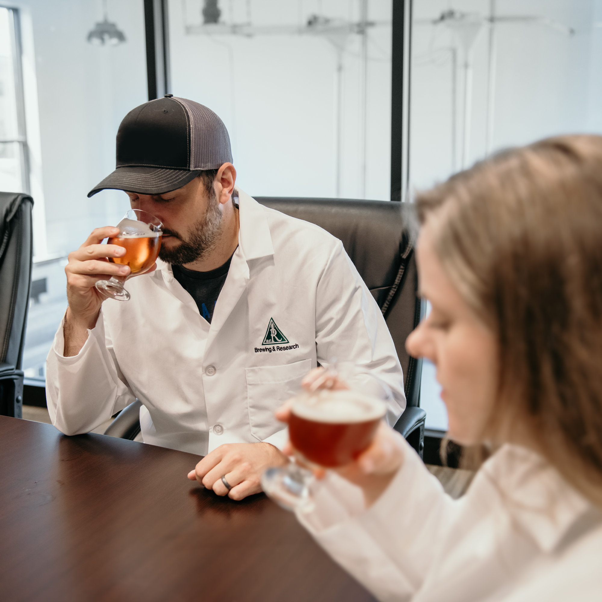 Brewing scientists evaluating samples